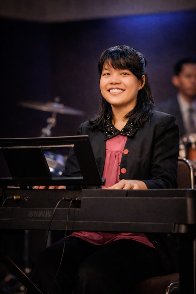 Pianist leading praise and worship session during church service at Padriadi Ministry Medan