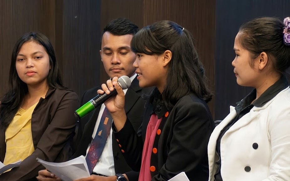 Young speakers sharing thoughts during a faith-based discussion session in a ministry event